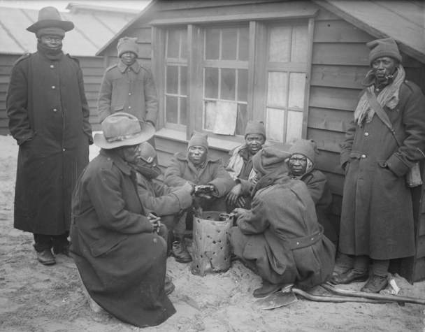 SANLC men round a brazier at their camp